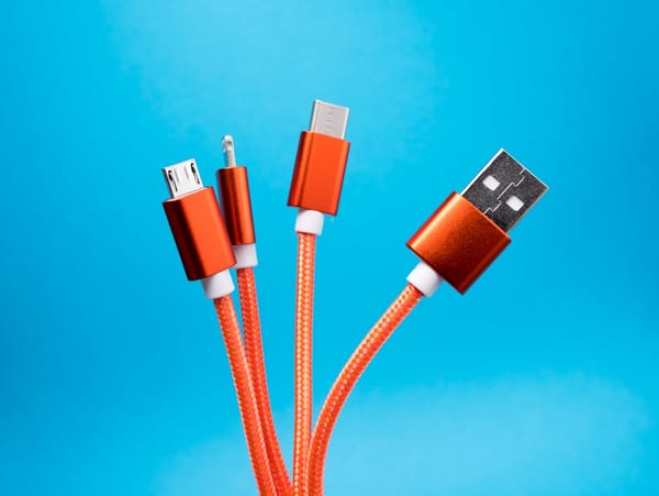 Coiled orange USB charging cables — illustrating the consumer charging accessory category